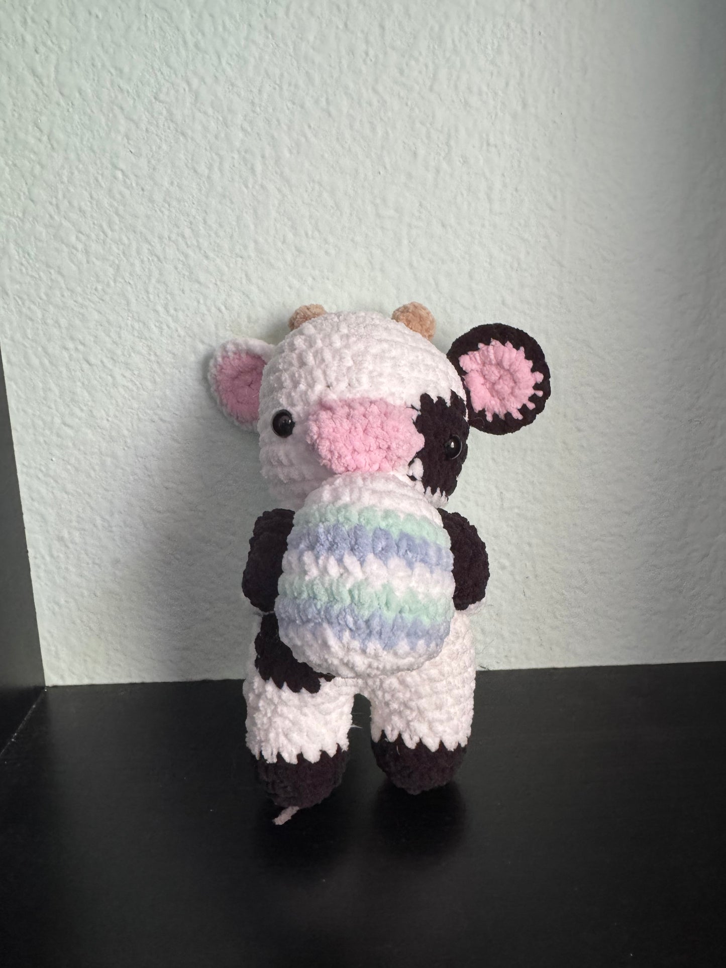 Cow holding a Easter egg