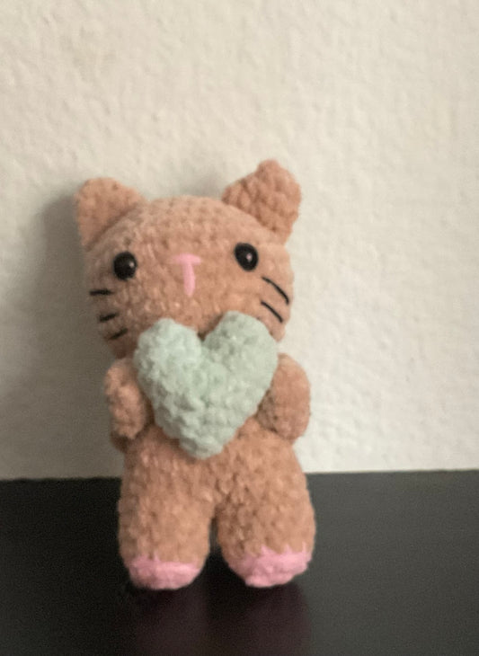 Cat holding a heart