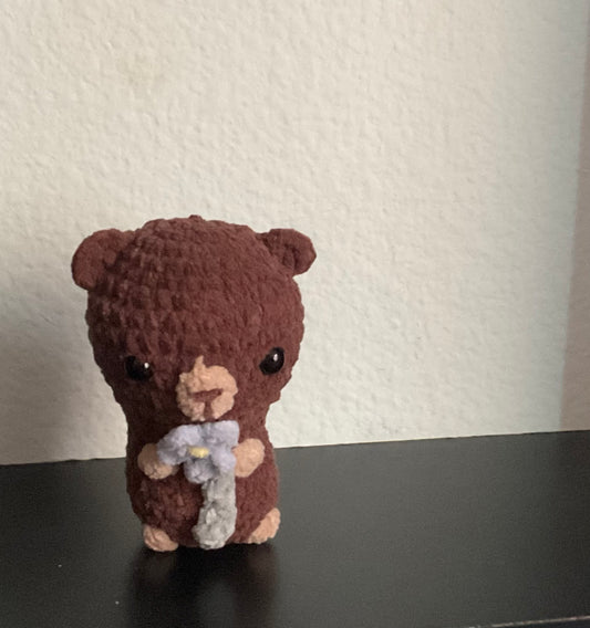 Bear holding a flower