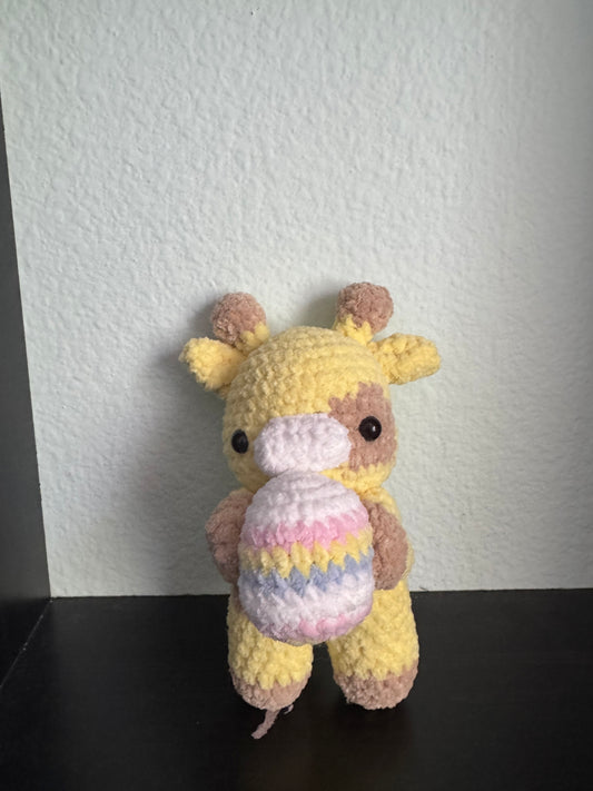 Giraffe holding a Easter egg